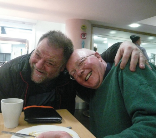 Two smiling residents of St George's Crypt homeless charity in Leeds